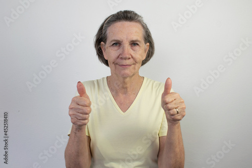 old female woman senior happy smile thumbs up retired aged expression friendly