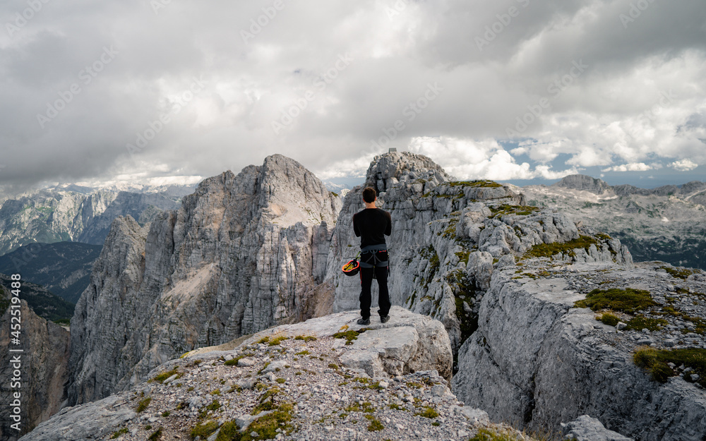 Young traveler exploring the world concept. Concept of alpine rock climbing.