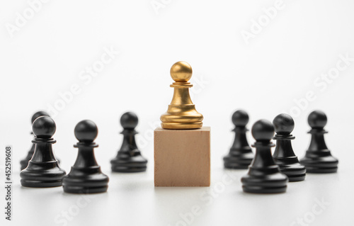 The leadership of the Golden Chess pawn standing on the box show influence and empowerment. Concept of business leadership for leader team  successful competition winner and Leader with strategy