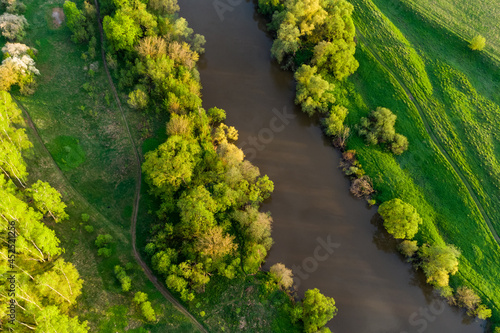 Small river in the middle of green landscape, aerial view