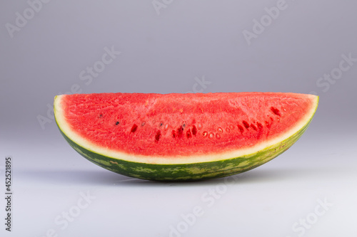 a quarter slice of watermelon isolated on a white background