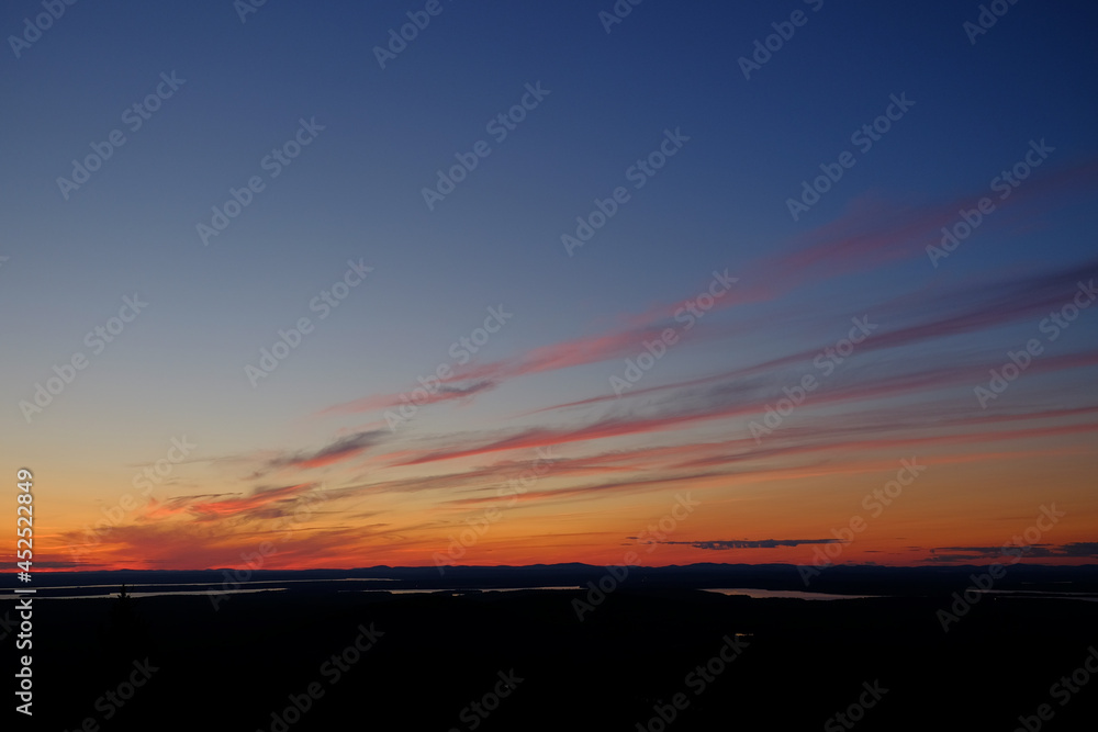 Fototapeta premium Beautiful sunset as seen from the top of Cadillac Mountain in Mane with the hundreds of bays and inlets