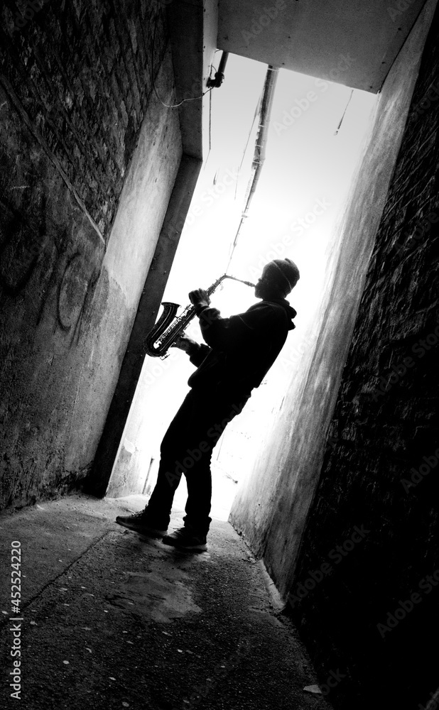 street sax player silhouette