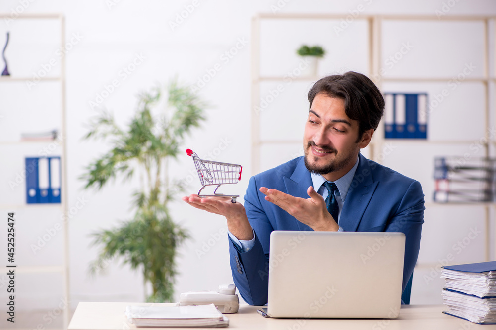 Fotografie Young male employee in e-commerce concept