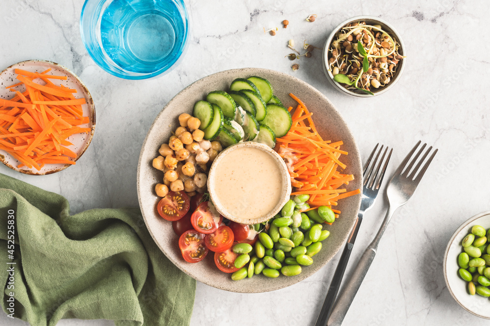 Vegan salad bowl with hummus sauce. Vegetable and bean buddha bowl Vegan salad bowl with hummus sauce. Vegetable and bean buddha bowl