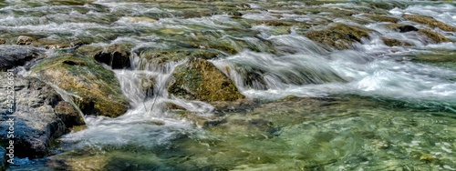 Fotografia At the creek with crystal clear water on a hot summer day