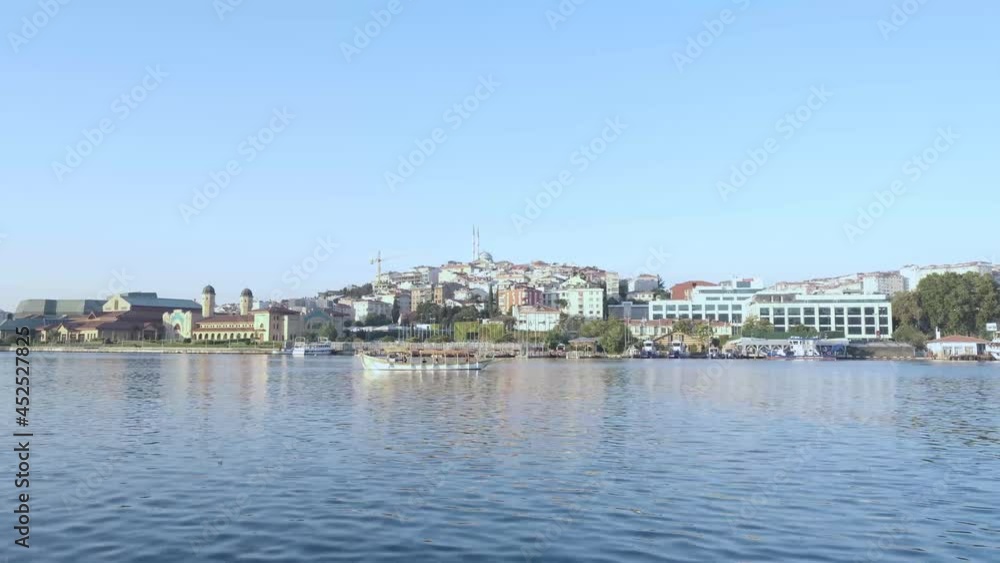 Istanbul, Turkey - 07.26.2021: historical Turkish nautical vessel boat carrying tourists and local people on the Golden Horn in a cloudless sunny summer day for traveling sea trip voyage holiday conce Istanbul, Turkey - 07.26.2021: historical Turkish nautical vessel boat carrying tourists and local people on the Golden Horn in a cloudless sunny summer day for traveling sea trip voyage holiday conce