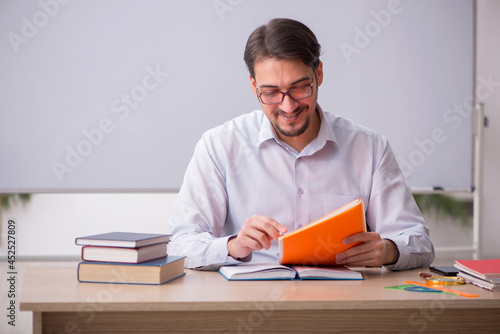 Young male teacher in front of whiteboard