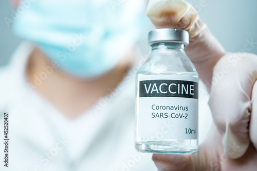 A little single glass bottle vial of new Covid-19 vaccine. Healthcare concept vaccination injection treatment.