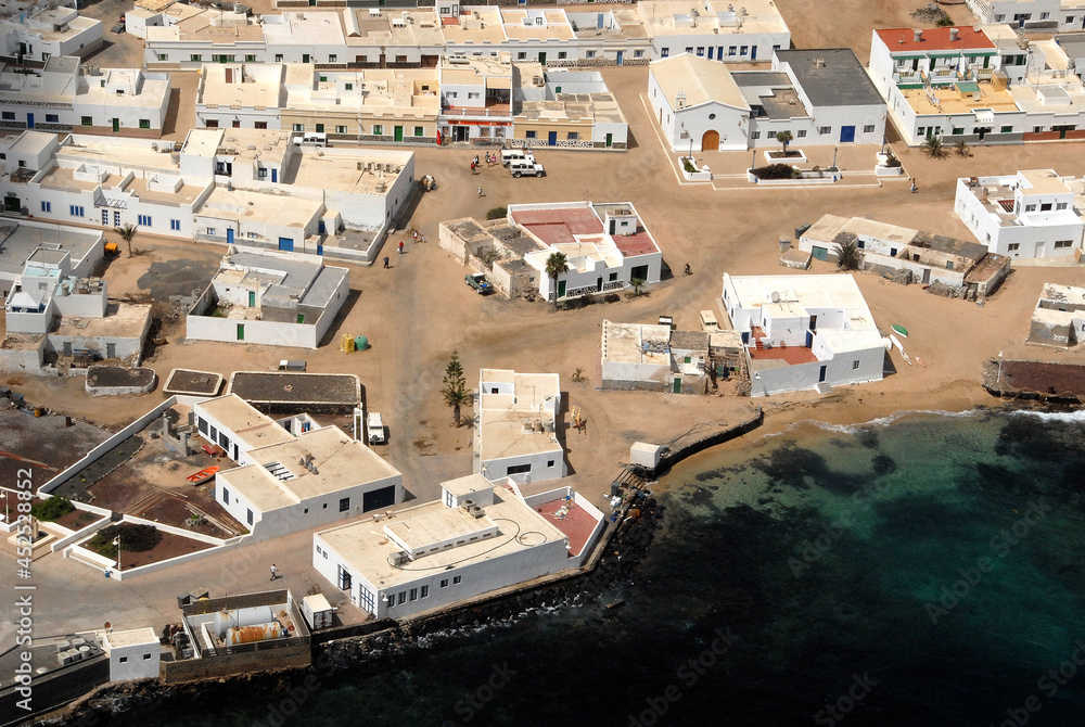 Fototapeta premium Fotografía aérea de la costa y pueblo de la Caleta del Sebo en la isla de La Graciosa, Canarias
