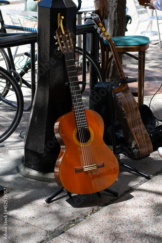 Guitars on guitar stands in the street played by a street musician 