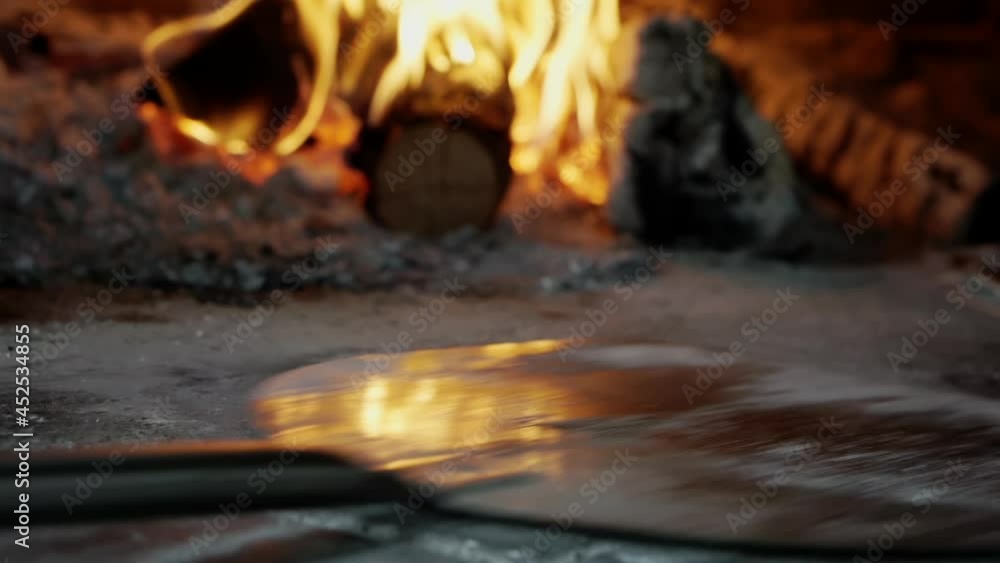 Cooking pizza in a wood-fired oven. Cooking pizza in a wood-fired oven.