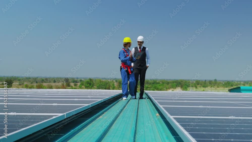 Engineer is consulting and giving advice to female foreman to install solar panels on factory roof, concept of construction of renewable energy plant, concept of environmental protection.
Engineer is consulting and giving advice to female foreman to install solar panels on factory roof, concept of construction of renewable energy plant, concept of environmental protection.