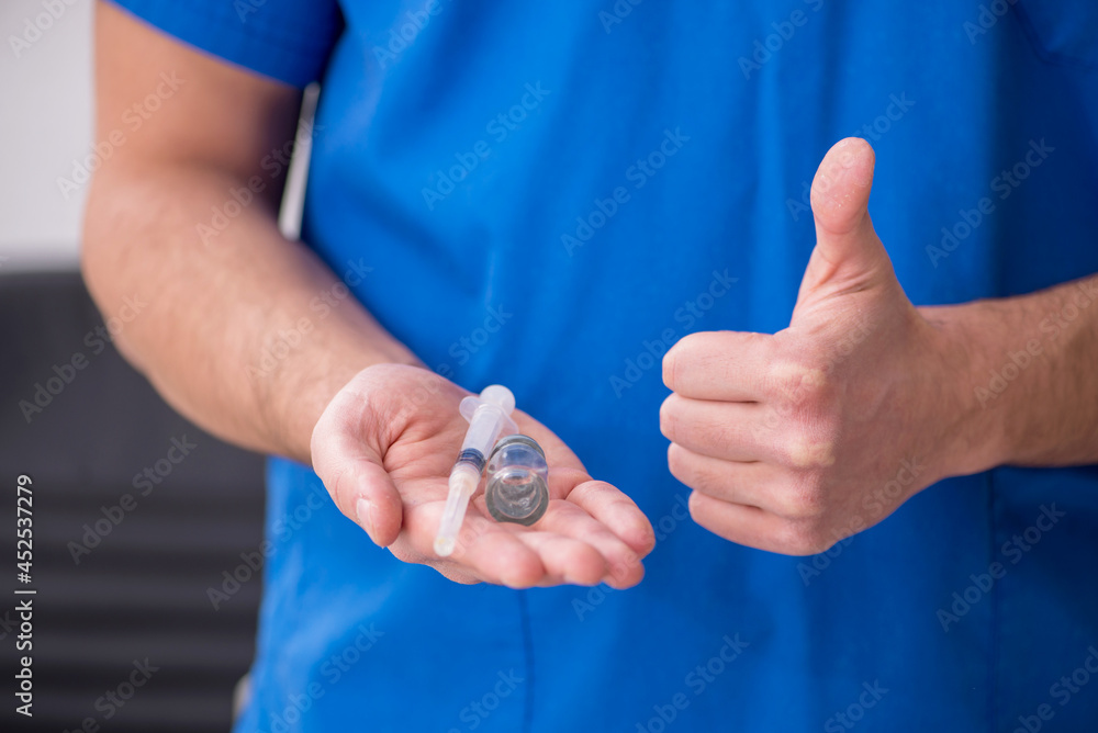 Fototapeta premium Young male doctor in vaccination concept during pandemic