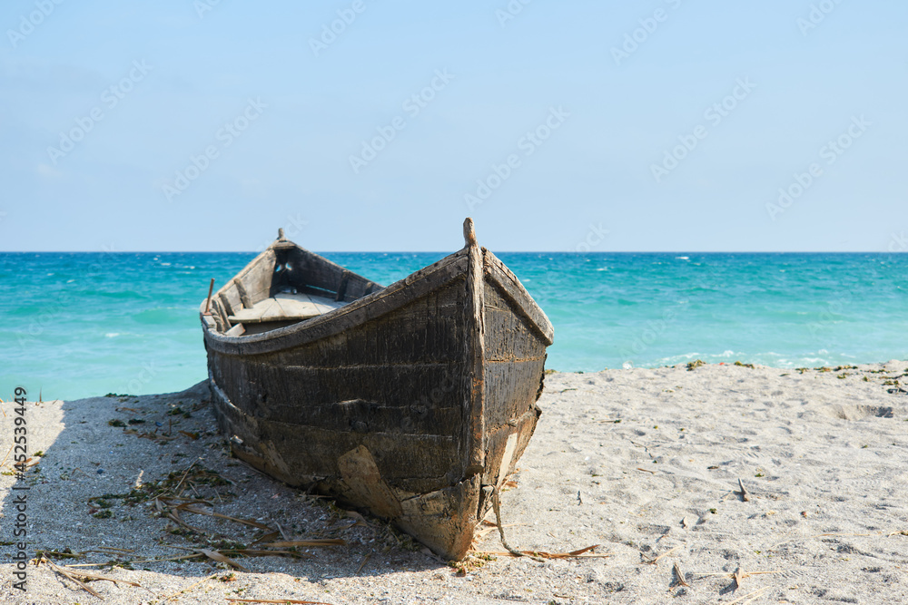 An old boat on the sand at Tuzla with the Black Sea on background An old boat on the sand at Tuzla with the Black Sea on background