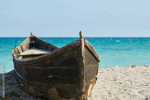 An old boat on the sand at Tuzla with the Black Sea on background