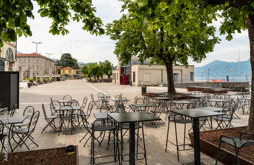 Tables and chairs of street cafe on lake Maggiore lakefront in Luino  Italy