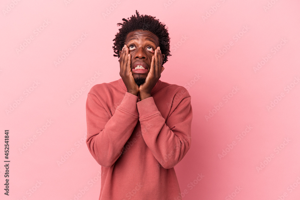 Young african american man isolated on pink background whining and crying disconsolately. Young african american man isolated on pink background whining and crying disconsolately.