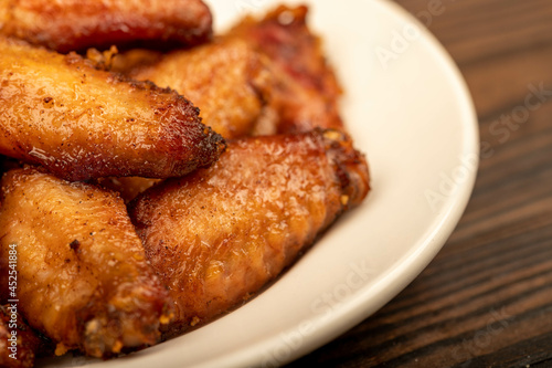 Fried chicken wings on a plate, close-up, selective focus.