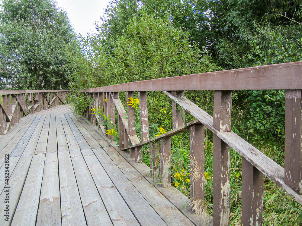 A wooden ecological trail in a public park. A wooden ecological trail in a public park.