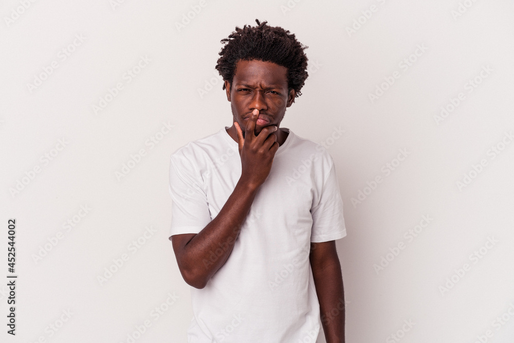Young african american man isolated on white background thinking and looking up, being reflective, contemplating, having a fantasy. Young african american man isolated on white background thinking and looking up, being reflective, contemplating, having a fantasy.