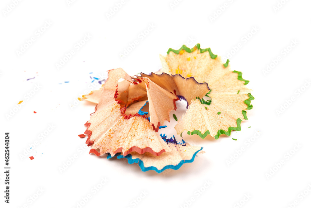 Wooden colored pencil sharpening shavings pile on white isolated background, top view, flat lay, copy space. Back to school concept. Wooden colored pencil sharpening shavings pile on white isolated background, top view, flat lay, copy space. Back to school concept.