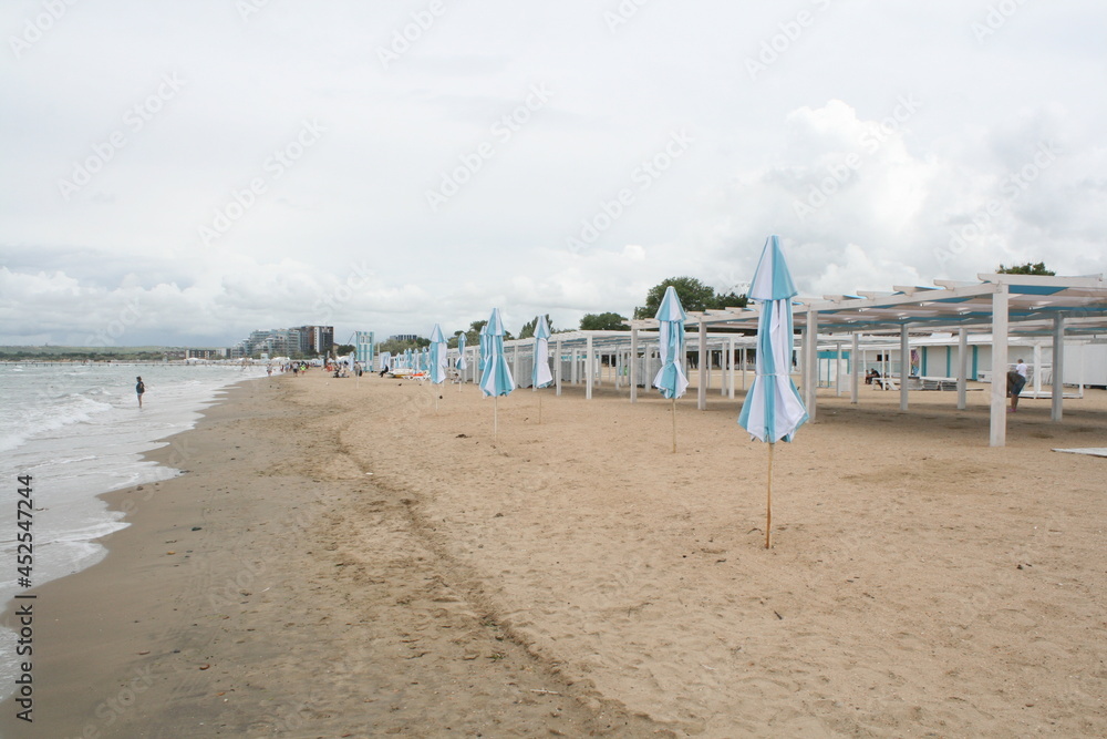 Deserted hotel beach with white sun loungers and awnings Deserted hotel beach with white sun loungers and awnings