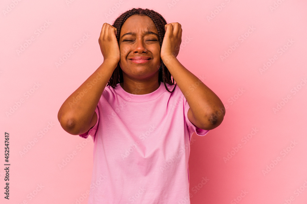 Young african american woman isolated on pink background crying, unhappy with something, agony and confusion concept. Young african american woman isolated on pink background crying, unhappy with something, agony and confusion concept.