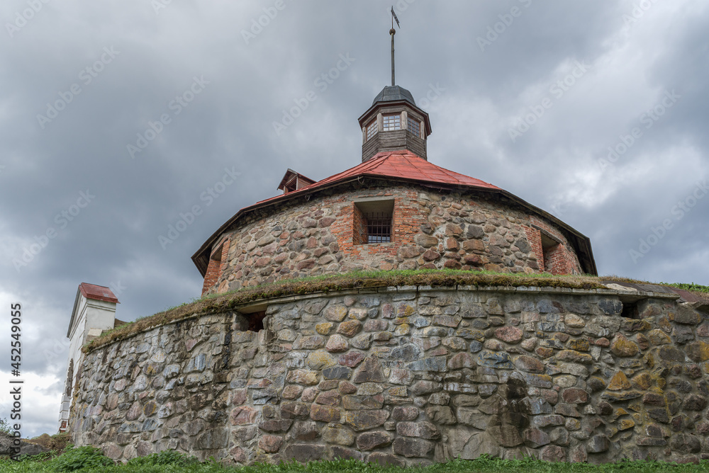 Fototapeta premium At the foot of the ancient Lars Torstensson Tower (Pugachev Tower) on a cloudy August day. Fortress Korela, Priozersk. Leningrad region, Russia