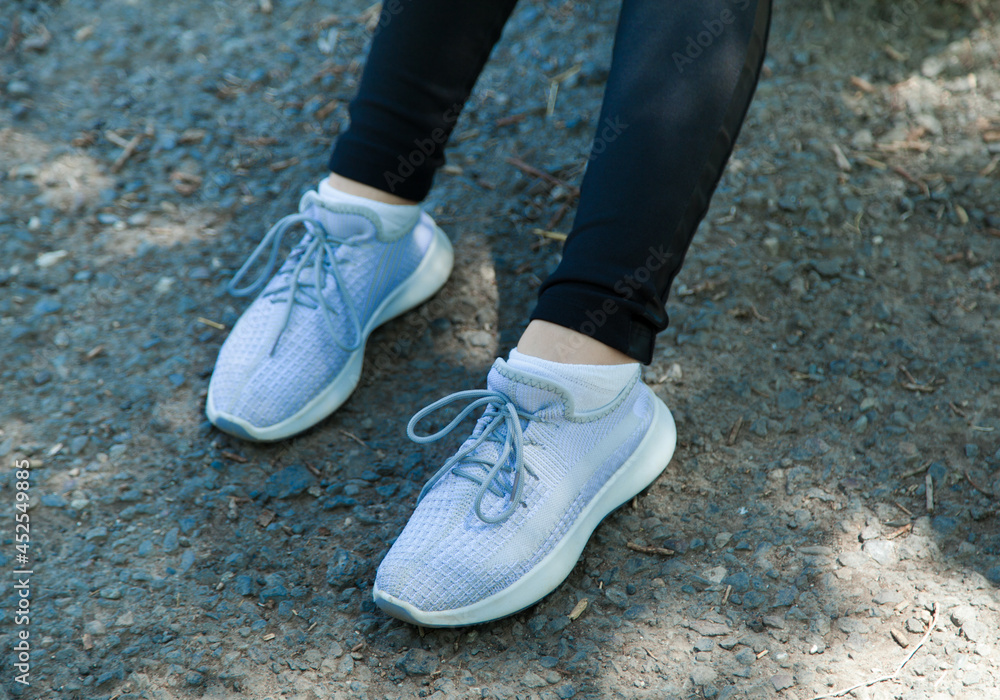 Fashionable woman in sneakers shoes. In the city. Fashionable woman in sneakers shoes. In the city.