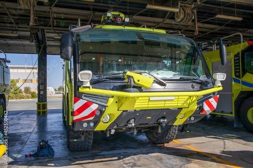 A fire truck stands at a working position, equipment for rescue and fire fighting at the airport. Rapid response equipment at the international airport. Rescue and fire fighting hangar.