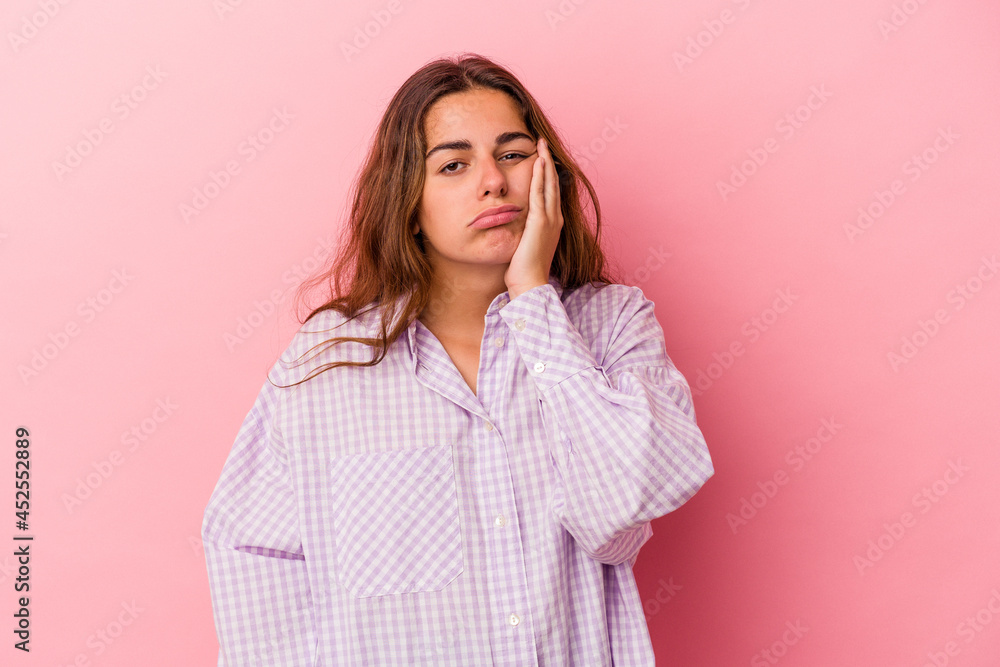 Young caucasian woman isolated on pink background who feels sad and pensive, looking at copy space. Young caucasian woman isolated on pink background who feels sad and pensive, looking at copy space.