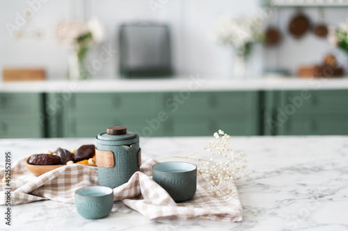Fototapeta Naklejka Na Ścianę i Meble -  Teal teapot set and bowl with dried fruits