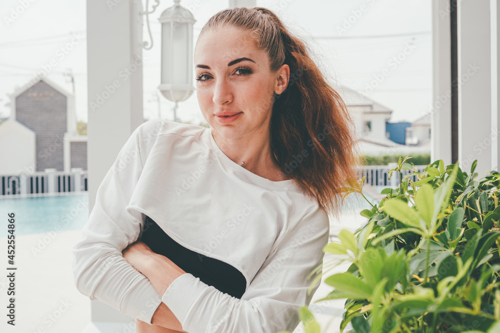 Portrait of Caucasian woman in sportswear in arms crossed position looking at camera. copy space Portrait of Caucasian woman in sportswear in arms crossed position looking at camera. copy space