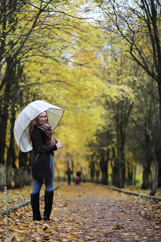 Young girl on a walk in the autumn park
