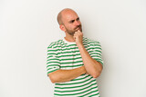 Young bald man isolated on white background thinking and looking up, being reflective, contemplating, having a fantasy.