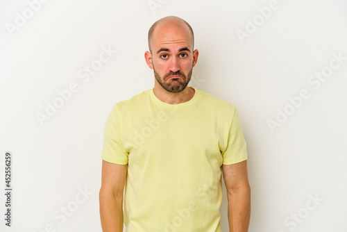 Young bald man isolated on white background sad, serious face, feeling miserable and displeased. © Asier