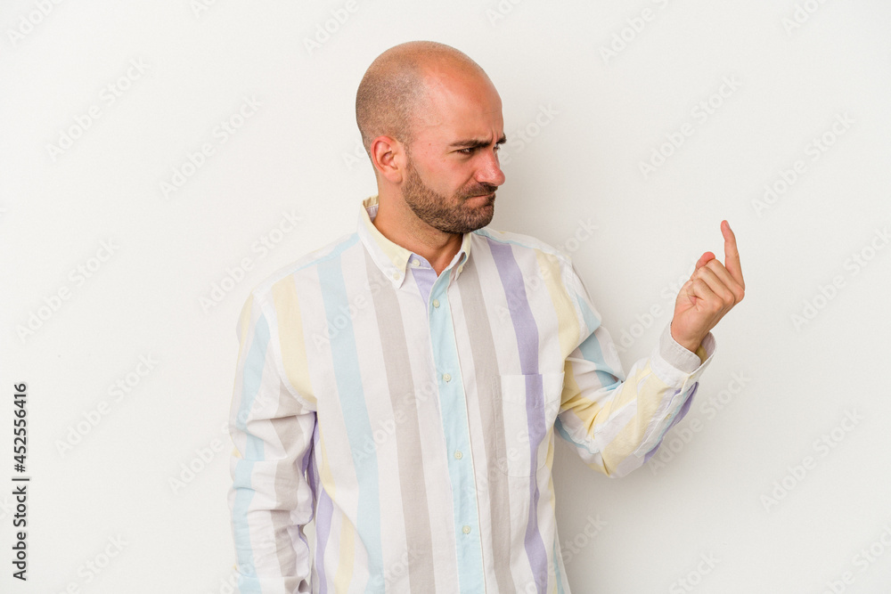 Young bald man isolated on white background pointing with finger at you as if inviting come closer. Young bald man isolated on white background pointing with finger at you as if inviting come closer.