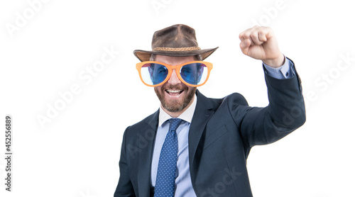 Happy man wear party glasses and cowboy hat in formalwear make winner gesture, celebration