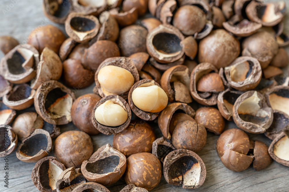 Pile of peeled Macadamia nuts on wooden table Pile of peeled Macadamia nuts on wooden table