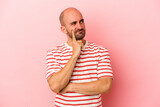 Young caucasian bald man isolated on pink background  contemplating, planning a strategy, thinking about the way of a business.