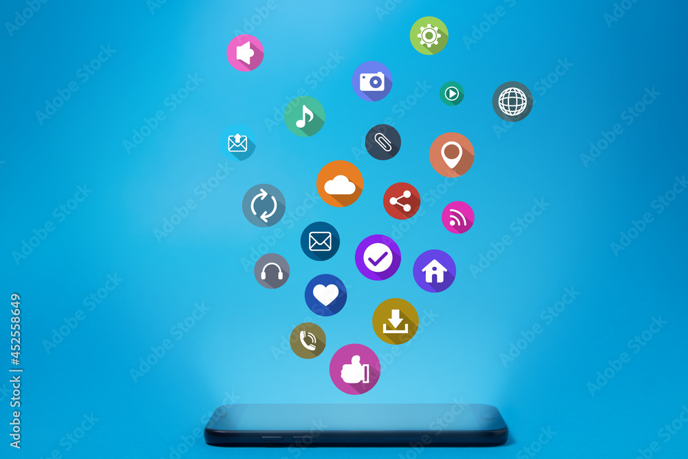 Mobile applications concept. Cell phone on a blue background. Mobile app icons Mobile applications concept. Cell phone on a blue background. Mobile app icons