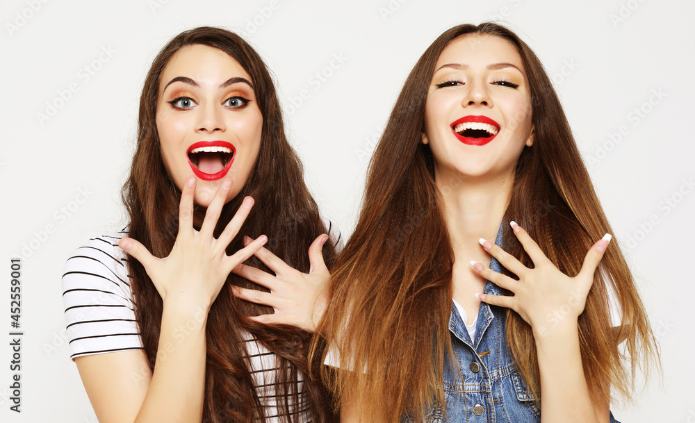 Two young girl friends having fun. Both making surprised faces. Two young girl friends having fun. Both making surprised faces.