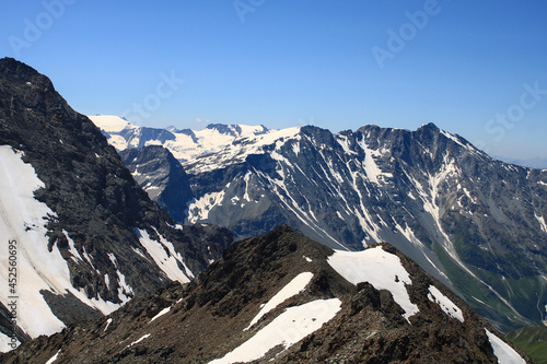 Snowcapped rocky summit at altitude in Savoy. Mountain landscape in the Alps with glaciers.