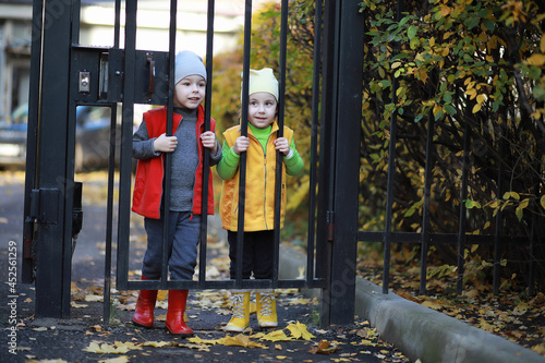 Children walk in the autumn park © alexkich