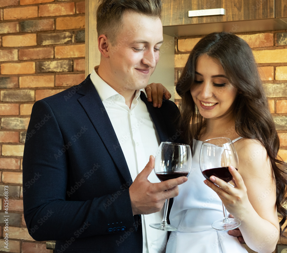 Bride and groom hold in their hands glasses with wine Bride and groom hold in their hands glasses with wine