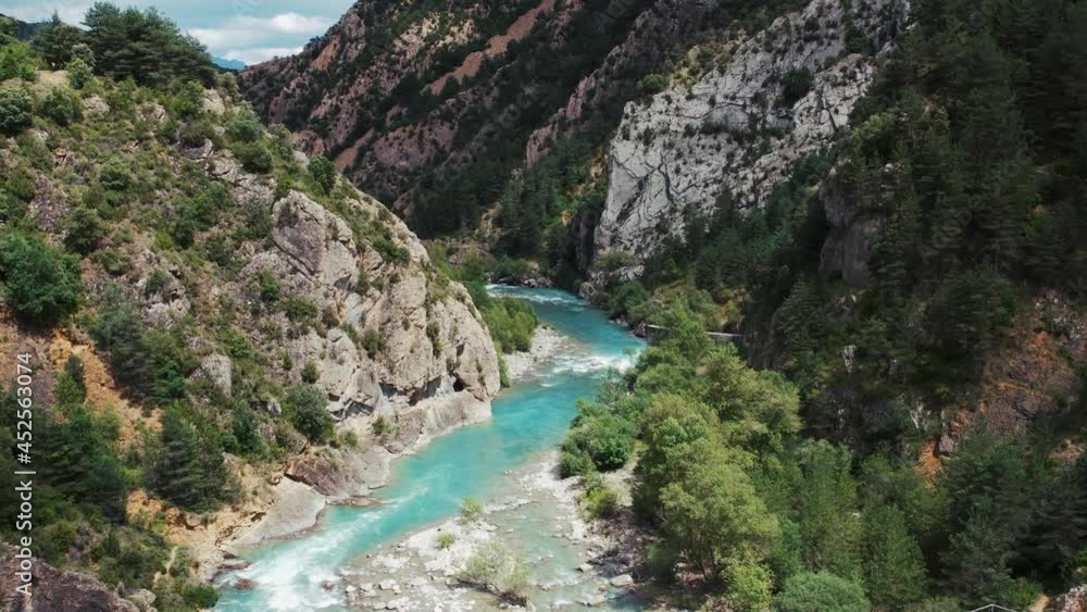 River in mountainous valley on sunny day River in mountainous valley on sunny day