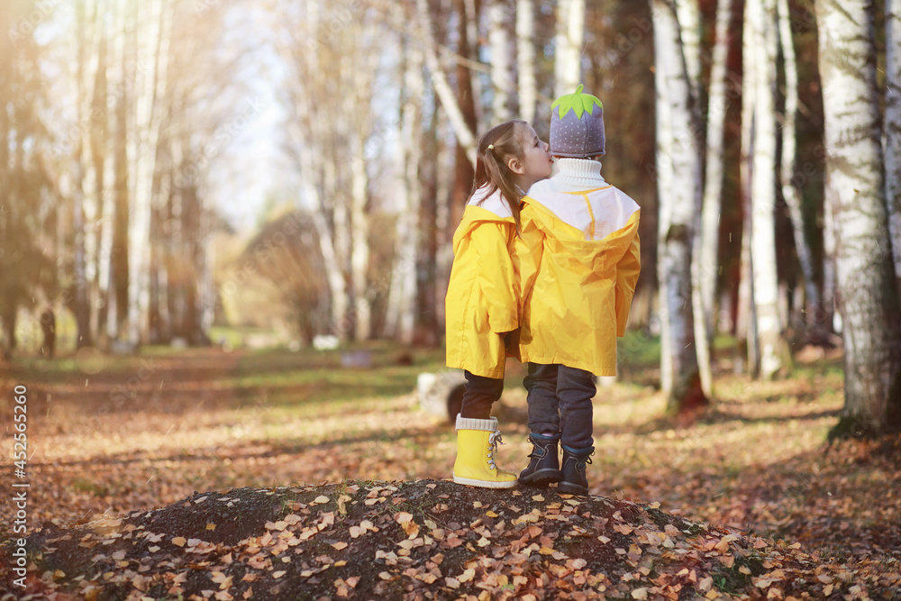 Children walk in the autumn park Children walk in the autumn park
