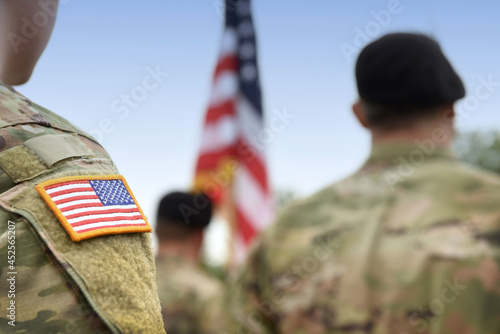 US soldiers. US army. USA patch flag on the US military uniform. Soldiers on the parade ground from the back. Veterans Day. Memorial Day.
