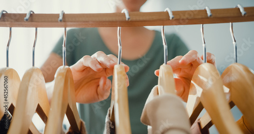 Photography Beautiful attractive young Asia lady choosing her fashion outfit clothes in closet living room at house or store